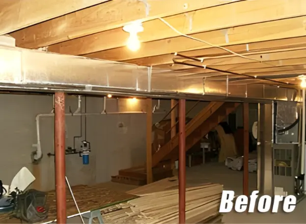 Basement before renovation showing unfinished space with bare walls and flooring