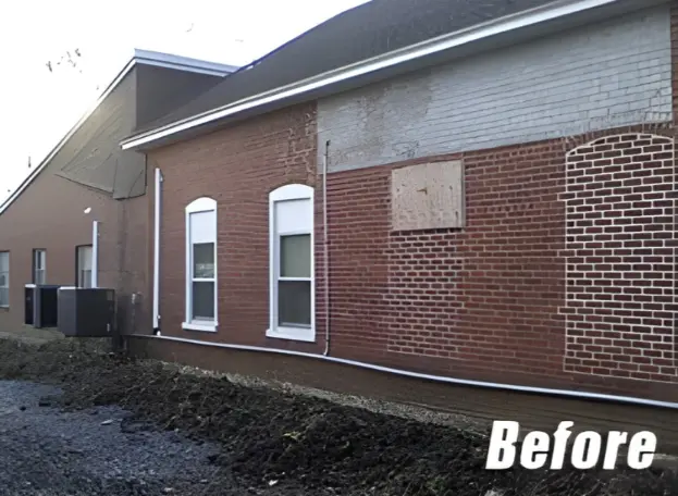 Brick commercial building exterior showing worn walls before siding renovation